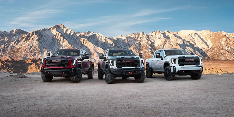 Three GMC sierra trucks parked side by side