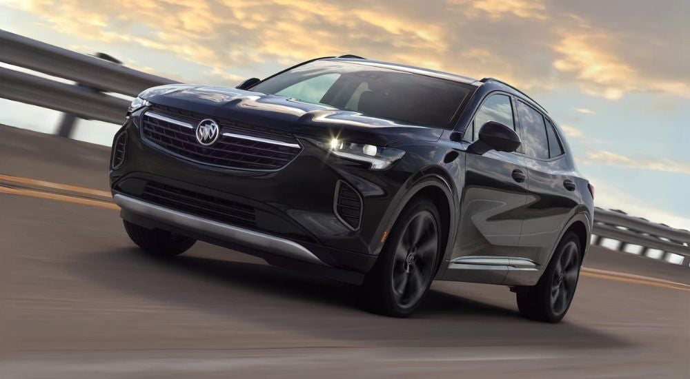 Black 2023 Buick Envision ST driving on a highway