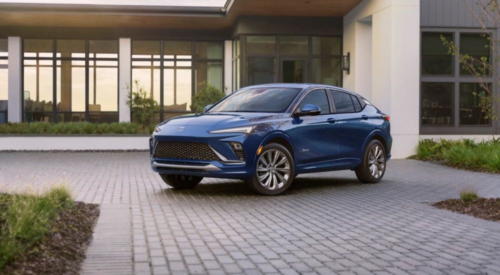 Blue 2024 Buick Envista Avenir parked near a building