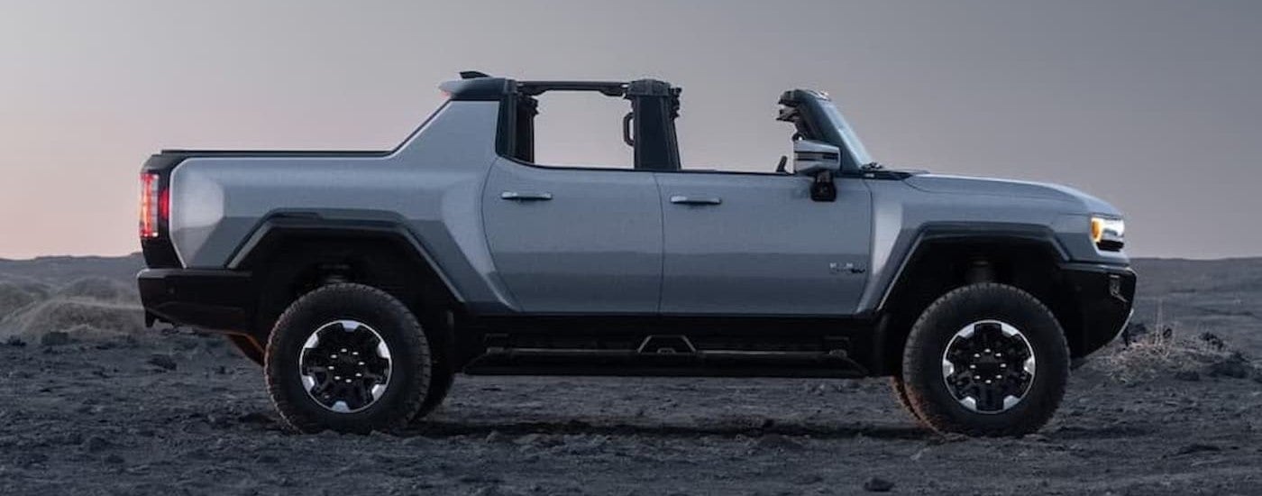 A silver 2026 GMC Hummer EV Pickup parked offroad.