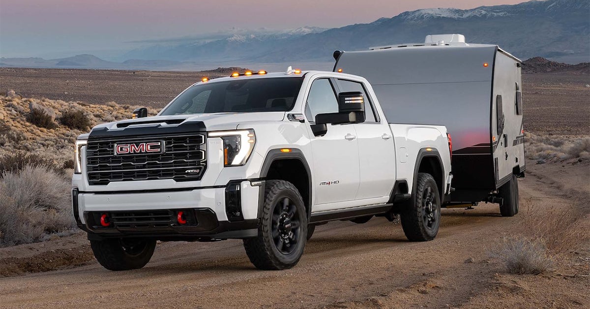 2025 GMC Sierra 2500 HD AT4x hauling a trailer in the desert