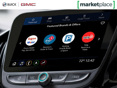 Car dashboard screen showing brand icons for ExxonMobil, Domino’s, parking, and Yelp under "Featured Brands &amp; Offers," with Buick and GMC logos above.