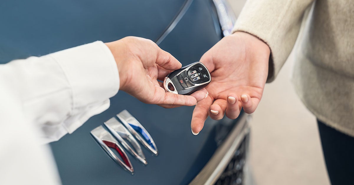 Buick salesperson giving a key to a customer