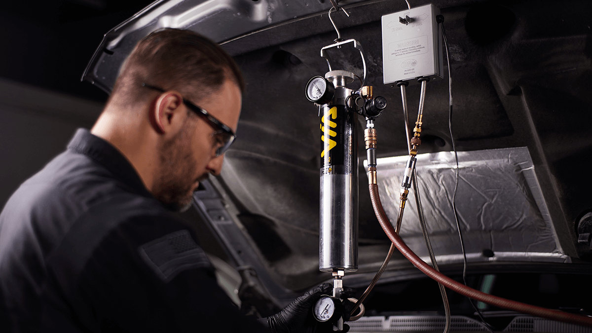 Ford technician installing genuine parts on an F-150 at Leif Johnson Ford