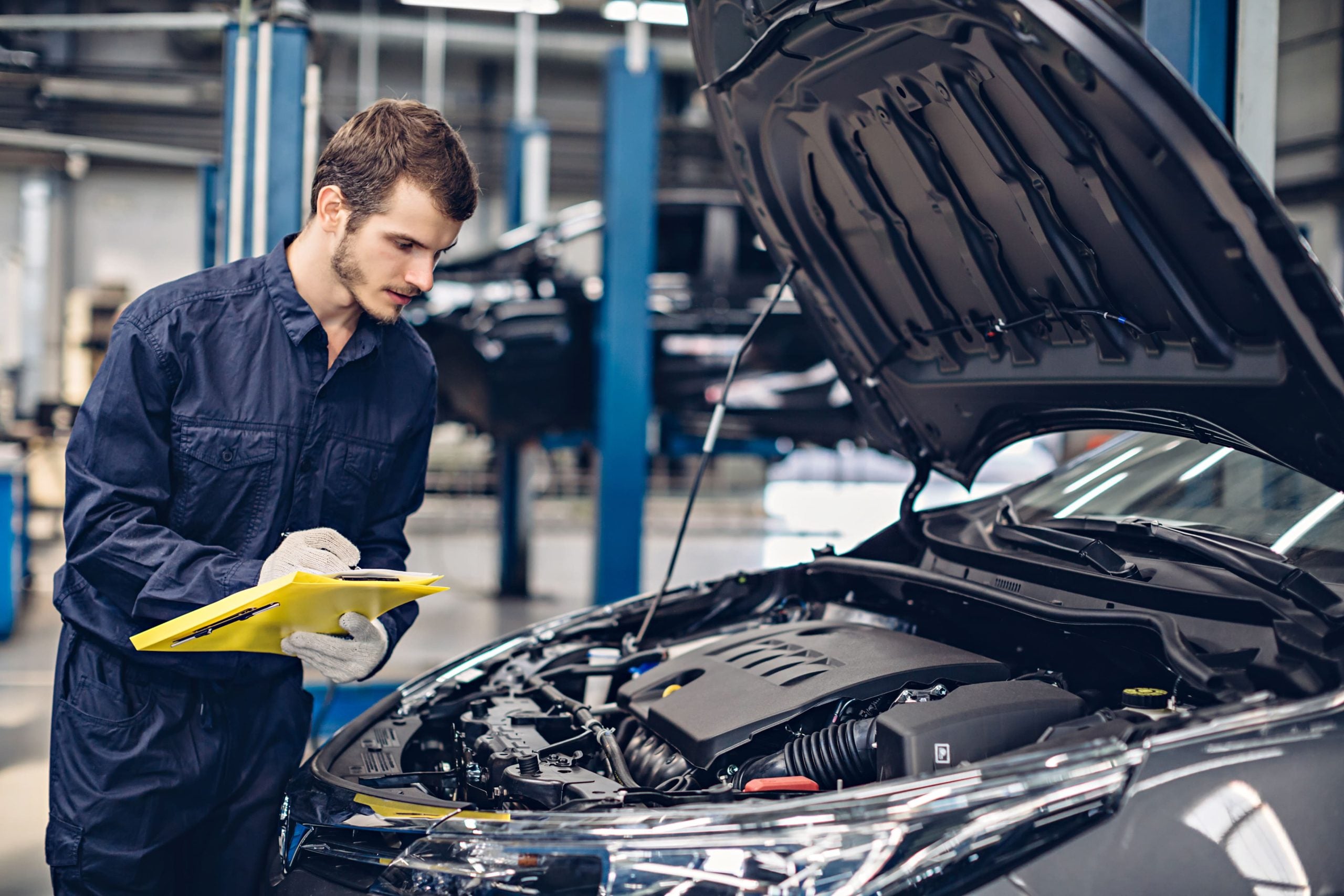 Mechanic expecting the engine in a car with the hood up