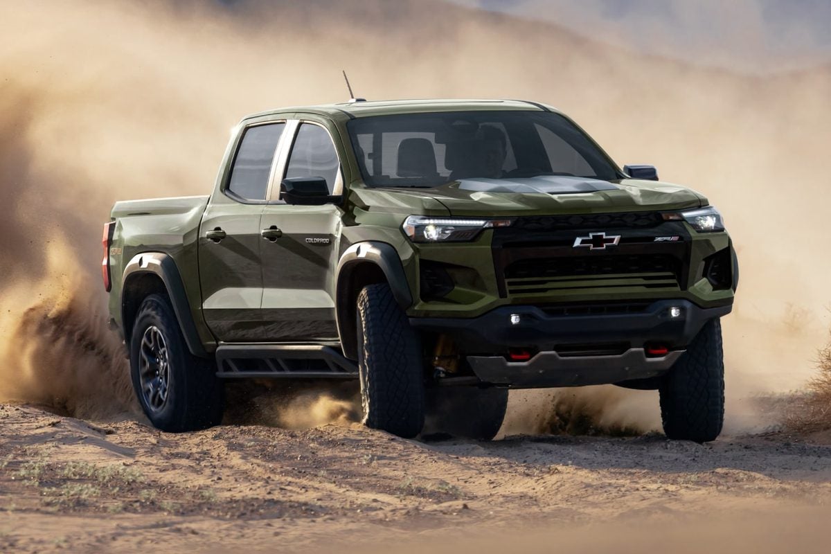 Green 2027 Chevy Colorado ZR2 kicking up dust on a dirt trail