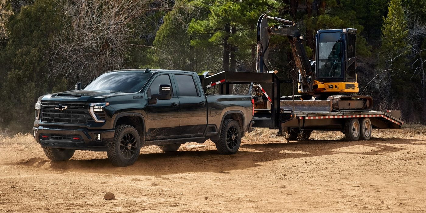 2026 Chevy Silverado 3500 HD hauling an excavator on a trailer