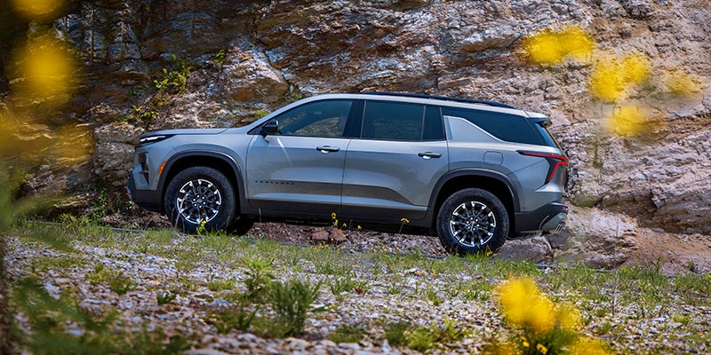 Gray Chevrolet Traverse parked roadside
