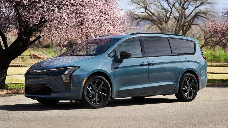 Blue 2027 Chrysler Pacifica Pinnacle under blossoming trees; trade in your vehicle at Ross Downing CDJR in Hammond, LA