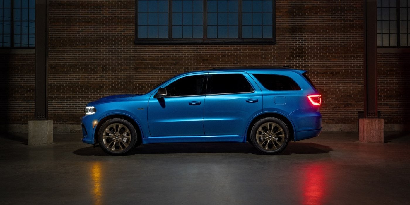 Blue 2027 Dodge Durango R/T 392 in profile beside a brick building, at Ross Downing CDJR in Hammond, LA