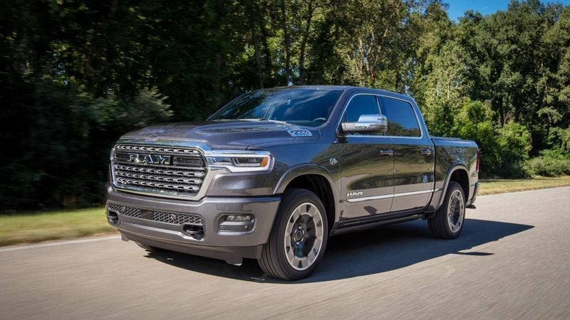 Gray Ram 1500 Limited Crew Cab on a tree-lined country road; Ram 1500 specials at Ross Downing CDJR in Hammond, LA