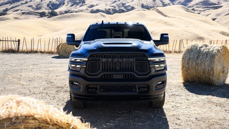 2027 Ram 2500 Rebel between hay bales on a ranch; Ram 2500 specials at Ross Downing CDJR in Hammond, LA