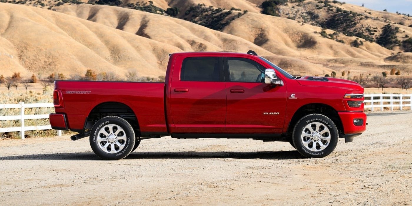 Red 2027 Ram 2500 Laramie Crew Cab in profile at a ranch, new at Ross Downing CDJR in Hammond, LA