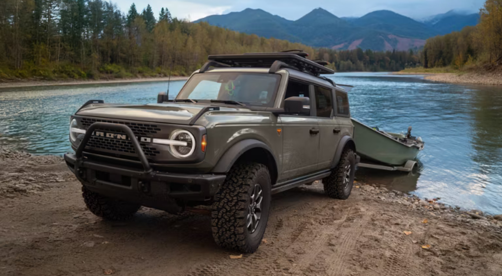 Green 2026 Ford Bronco Sport Badlands towing a boat