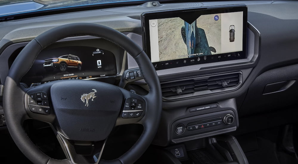 Steering wheel and dashboard interface of a 2026 Ford Bronco Sport.