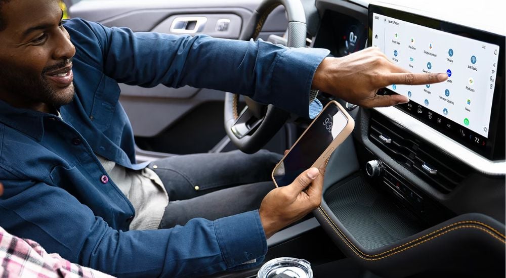 A person setting up their infotainment display in a 2027 Ford Explorer.