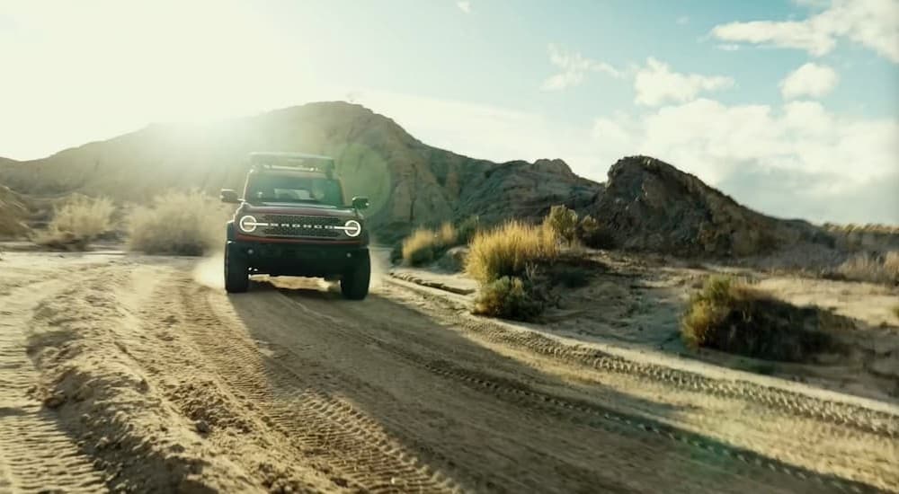 A green 2026 Ford Bronco off-roading.