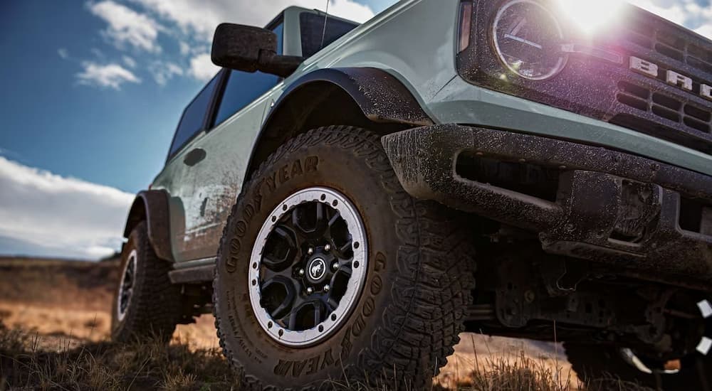 Close-up of a wheel on a blue 2023 Ford Bronco.