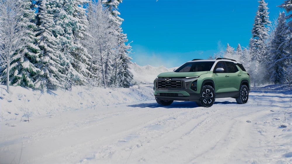 Image of a green 2025 Chevrolet Equinox driving in the snow