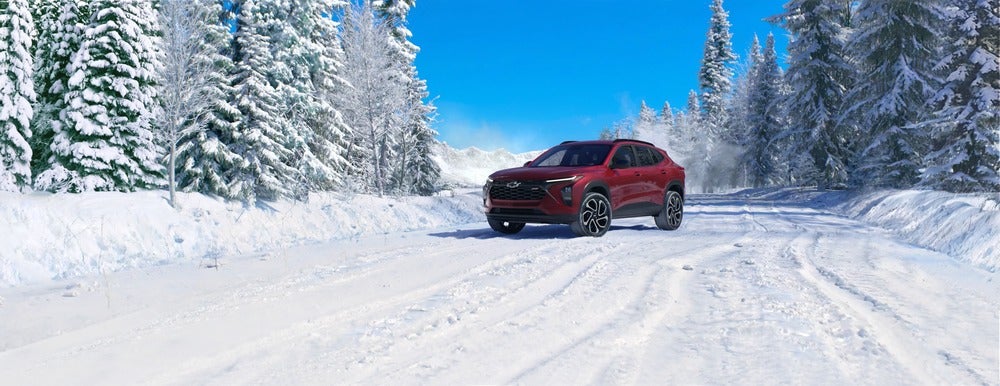 Red 2025 Chevy Trax driving in the snow