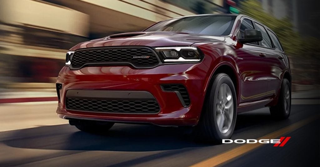 a red 2026 Dodge Durango drives down a road in Medina, OH