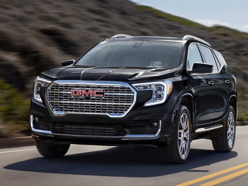 GMC SUV driving on road