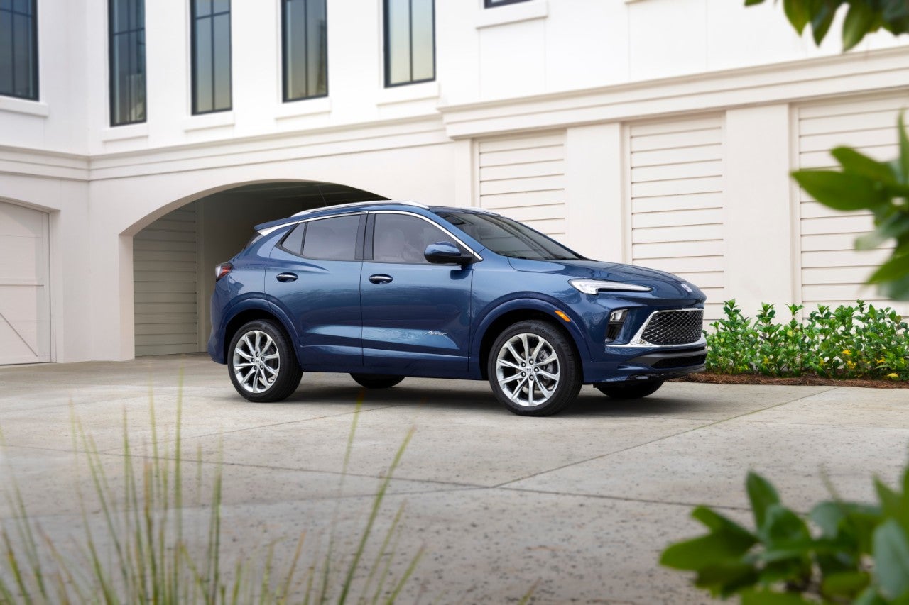 Front 7/8 view of the 2024 Buick Encore GX Avenir in Ocean Blue Metallic.