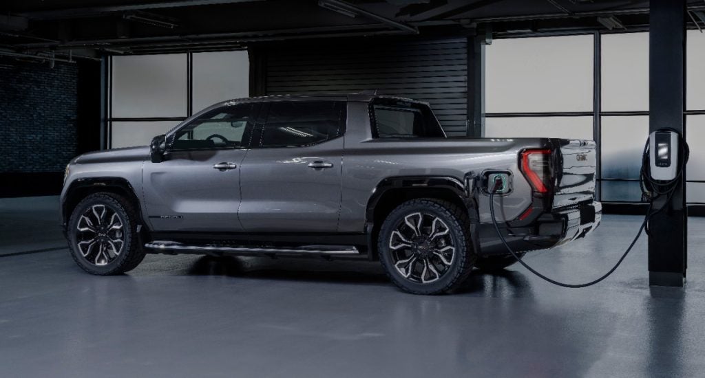 GMC Sierra EV Edition 1 plugged into a charging station. The foundation of the all-new Sierra EV is GM's revolutionary Ultium Platform.