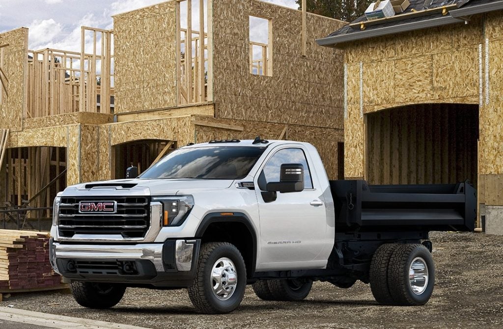 GMC 3500 HD chassis cab truck parked in front of a construction site