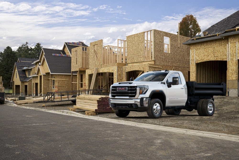 GMC Sierra HD work truck parked outside of a new neighborhood under construction