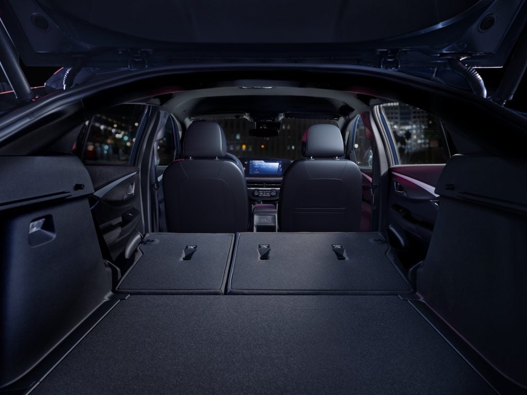Interior image of Buick 2026 Envista Preferred, showing Ebony seats with Slate interior accents. Back seats are down showing roomy trunk area