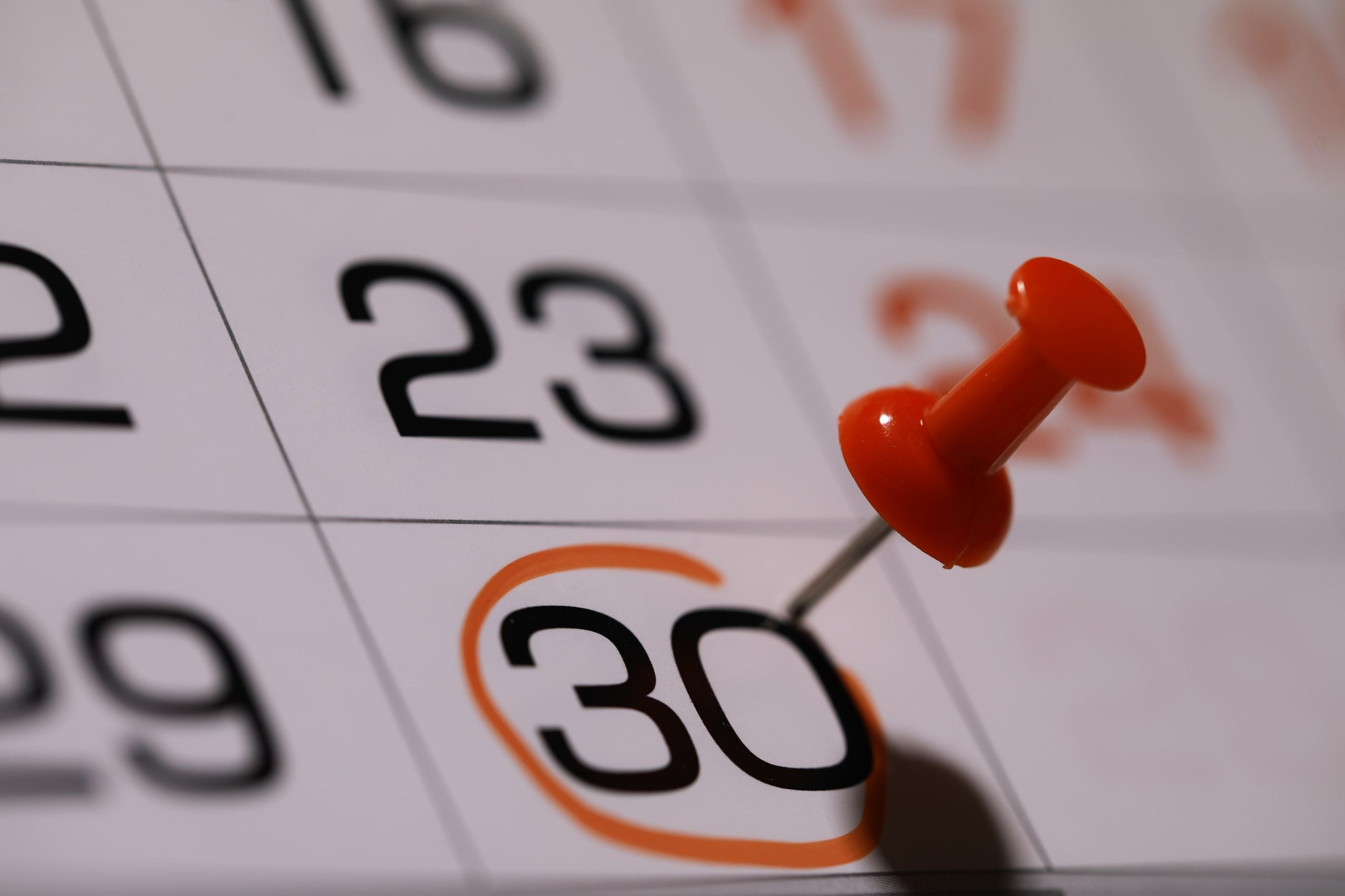 Marked calendar with the 30th of the month circled with a thumbtack in it