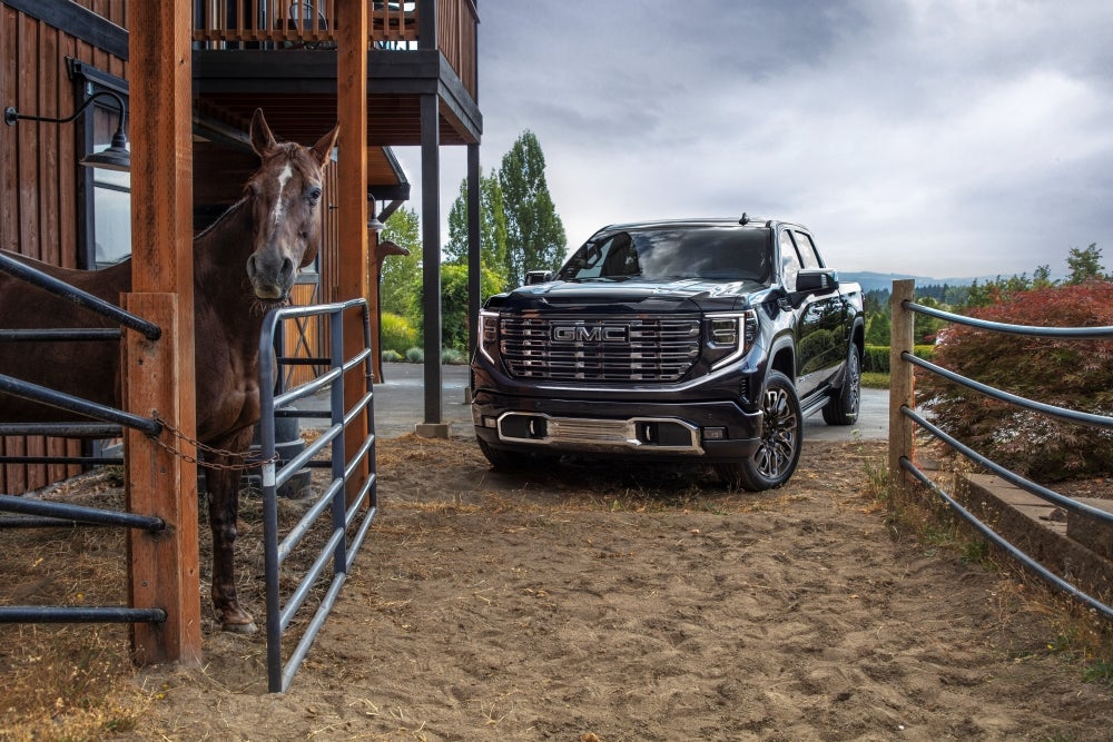 GMC Sierra 1500 Denali Ultimate parked next to a horse stall