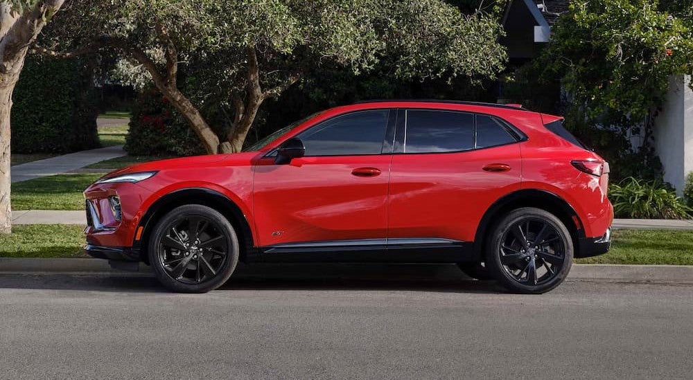 A red 2026 Buick Envision parked in a city.