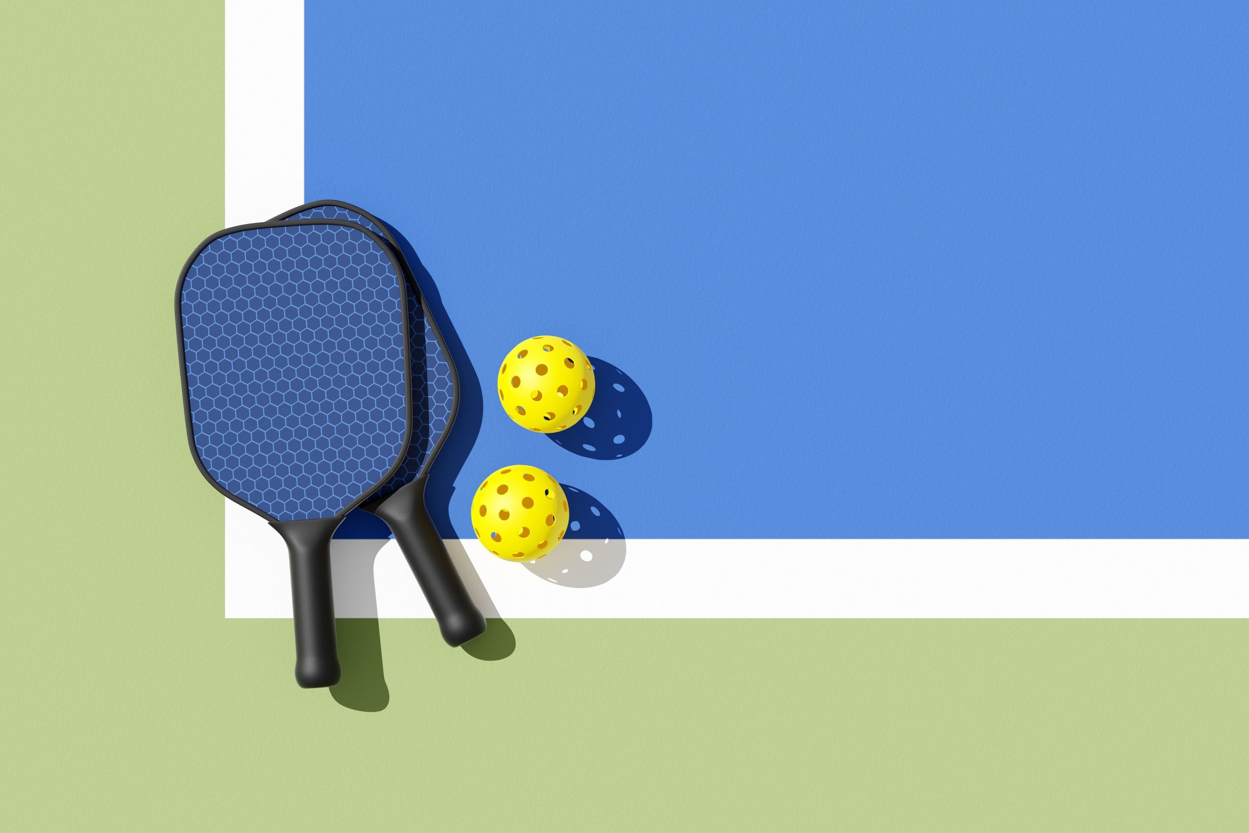 Pickleball paddles and balls on the corner of a court