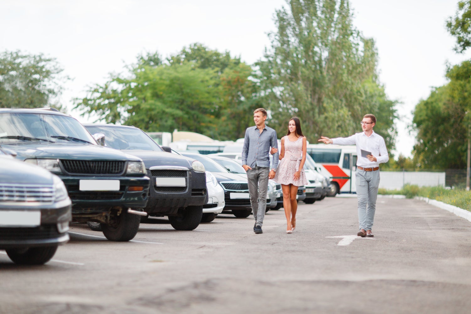 Couple Touring Outdoor Used Car Lot