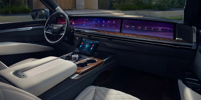 Luxury 2025 Cadillac Escalade interior featuring a wide dashboard with digital screens and a modern console.