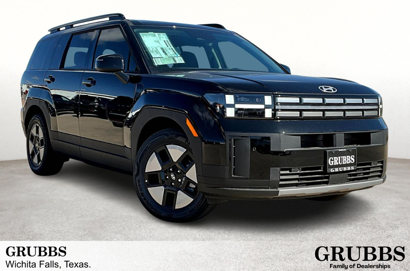 A sleek black Hyundai-Santa-Fe-Hybrid is shown at an angle, highlighting its modern design and chrome accents. The setting is a dealership with the name "GRUBBS" displayed.