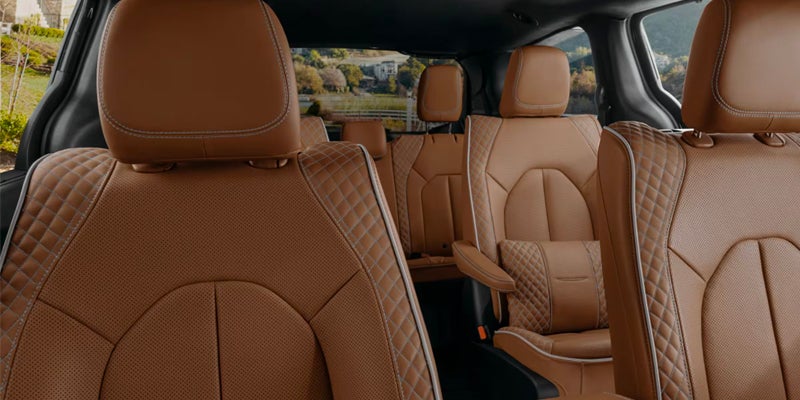 Luxury 2025 Chrysler Pacifica interior with brown leather seats and diamond stitching.