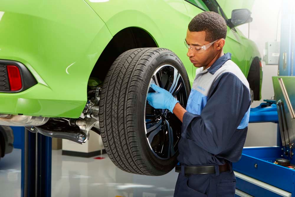 Honda service technician rotating tires