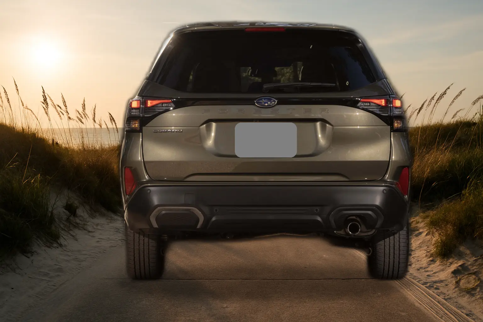 Compact SUV parked at a sandy Jacksonville beach access ramp during golden hour with dunes nearby