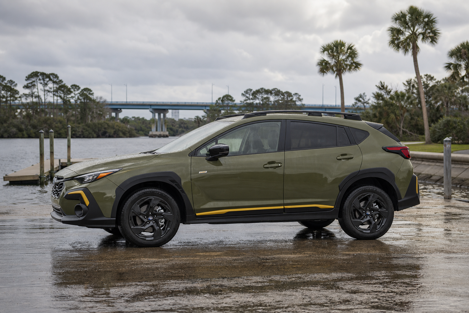 Compact crossover parked at a wet Jacksonville boat launch under a cloudy sky after summer rain