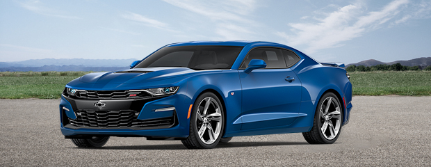 A sleek blue sports car parked outdoors on a sunny day. The car features a shiny finish, sharp lines, and chrome rims, conveying speed and elegance.