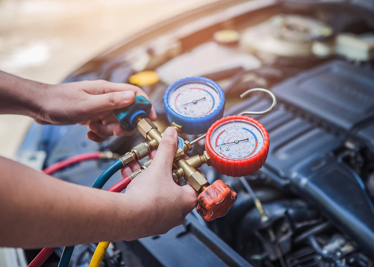 INFINITI service technician checking an A/C system