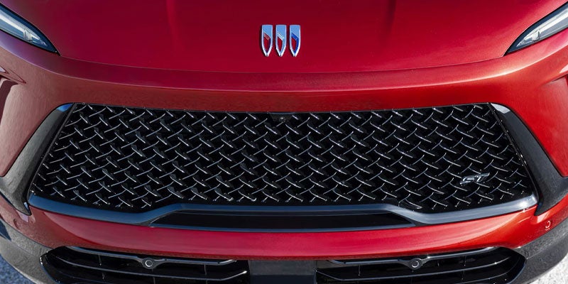 Front view close-up of a red Buick vehicle grille and emblem.
