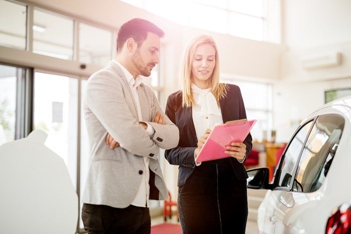 Customer talking with salesperson about when to trade in your Chevrolet vehicle