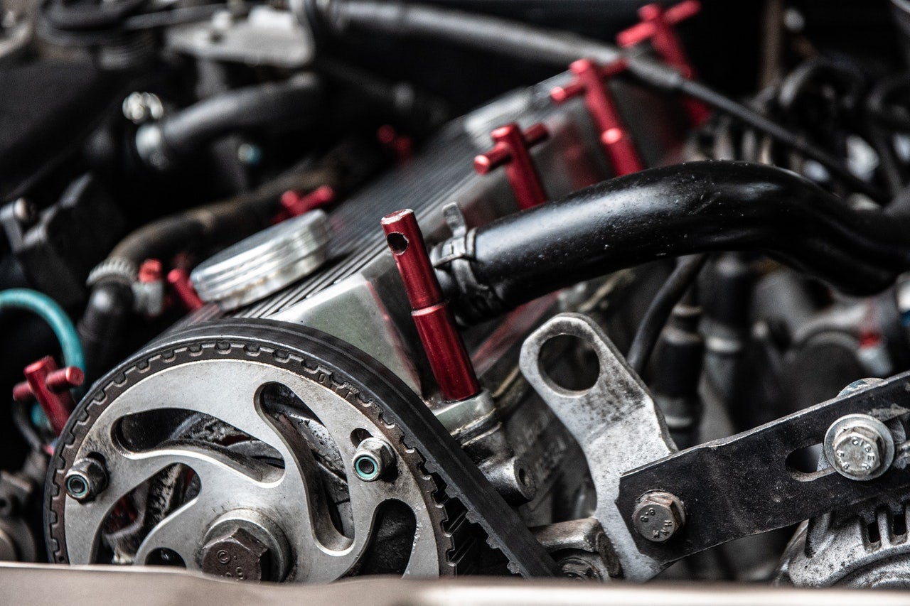 Chevy service inspecting a timing belt