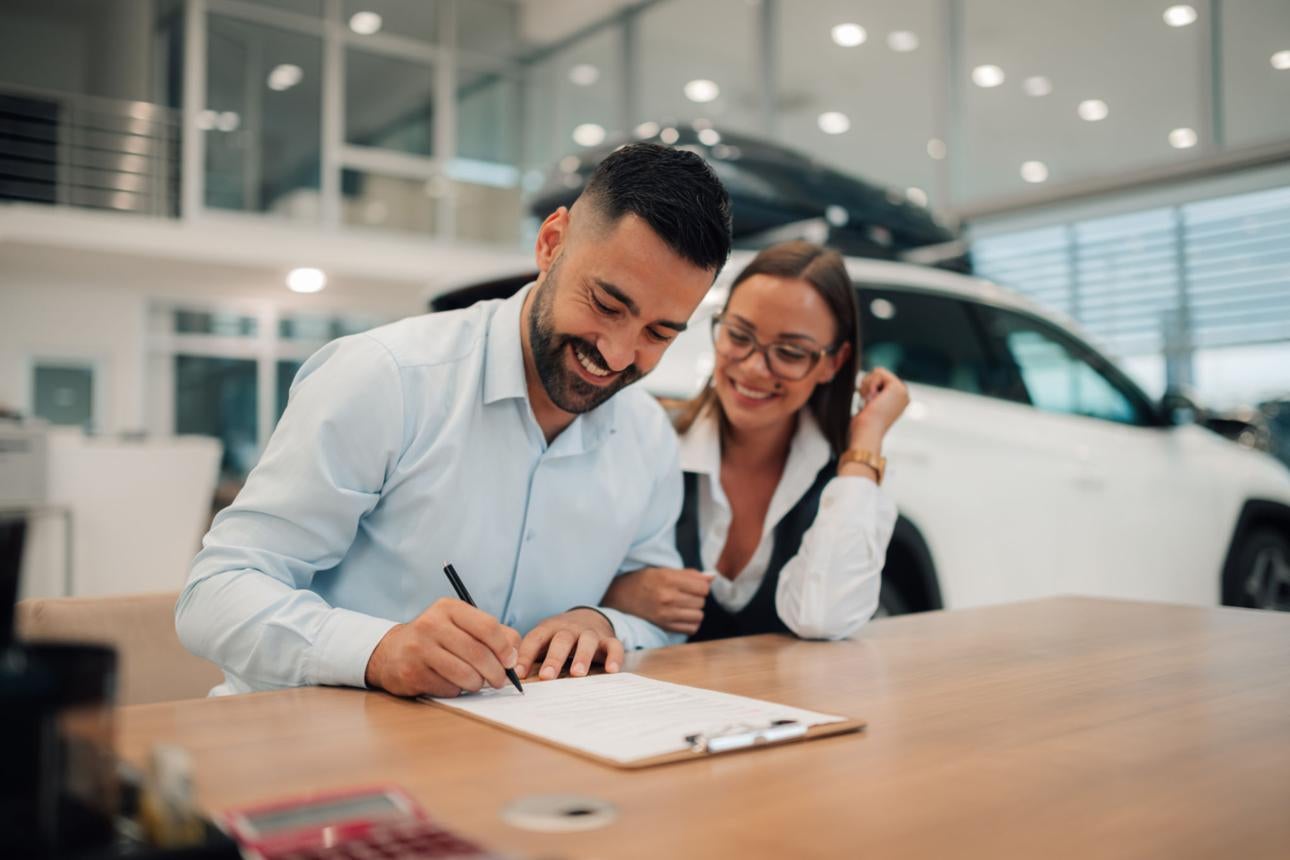 Customer reviewing a complete out-the-door vehicle price breakdown with a Heritage Auto Logan sales consultant in Logan, Utah.