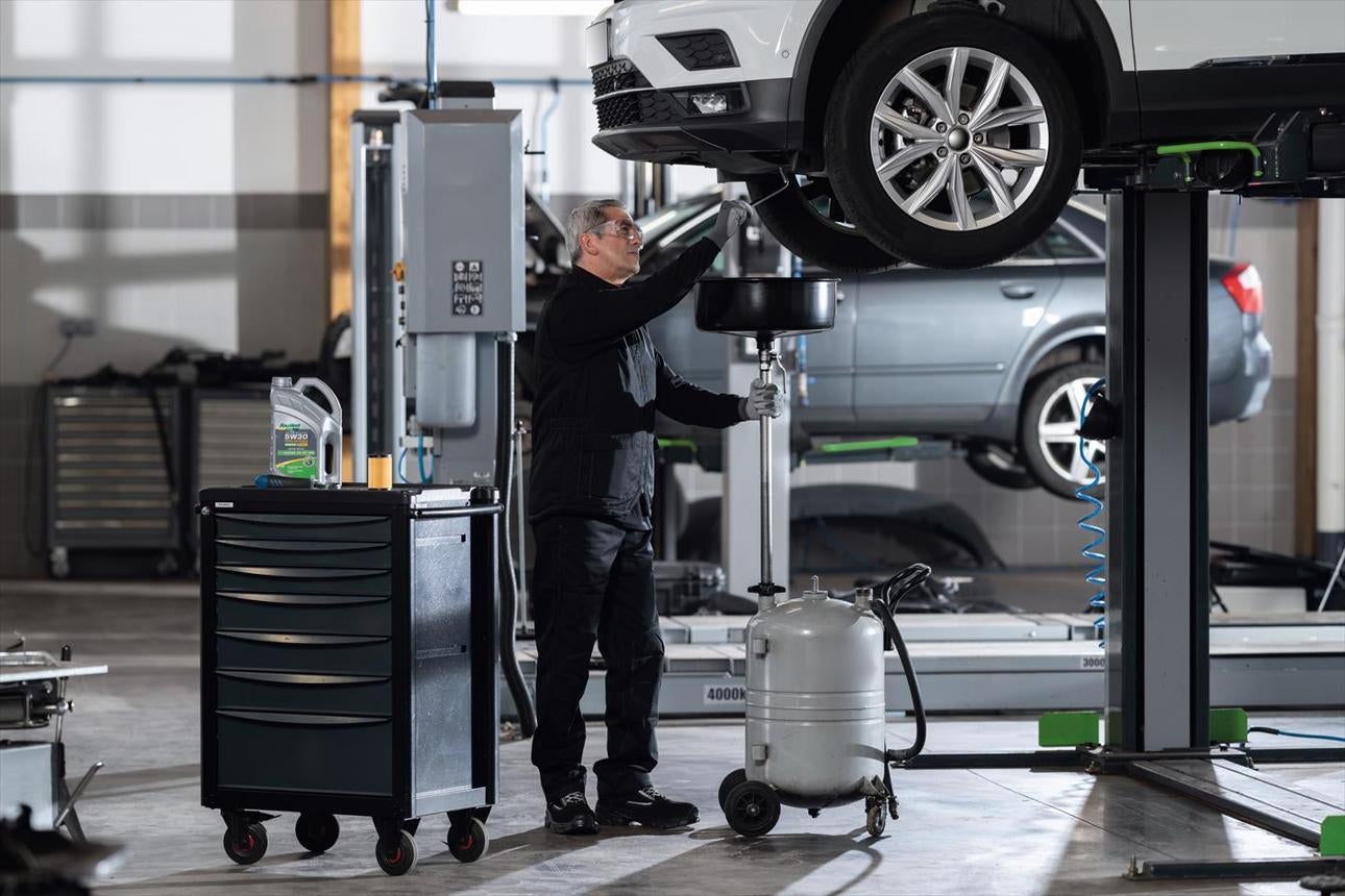 Certified technician performing an oil change on a Jeep vehicle at Heritage Auto Logan's service department in Logan, Utah.