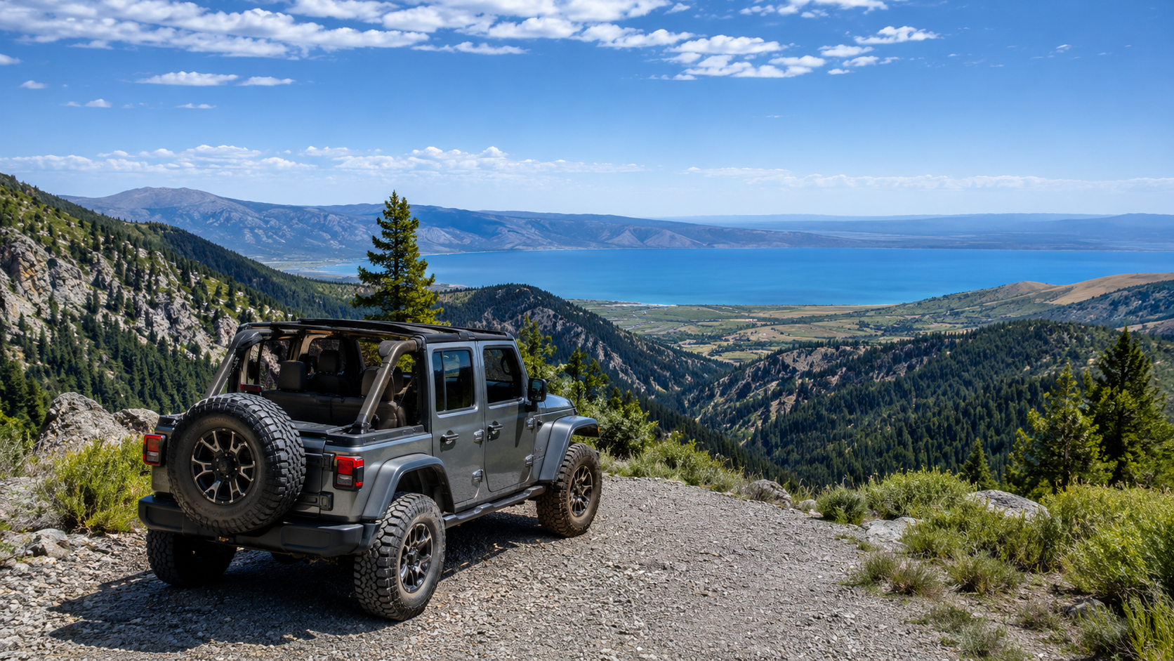 Jeep overlooking Bear Lake from a scenic mountain overlook near Logan Canyon in northern Utah.